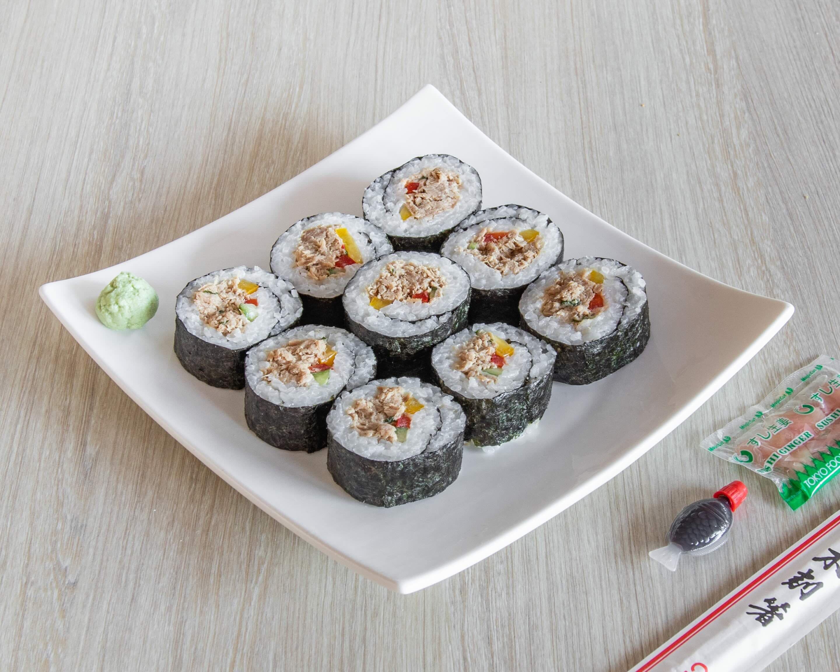Fresh tuna and chicken sushi arranged on a white plate